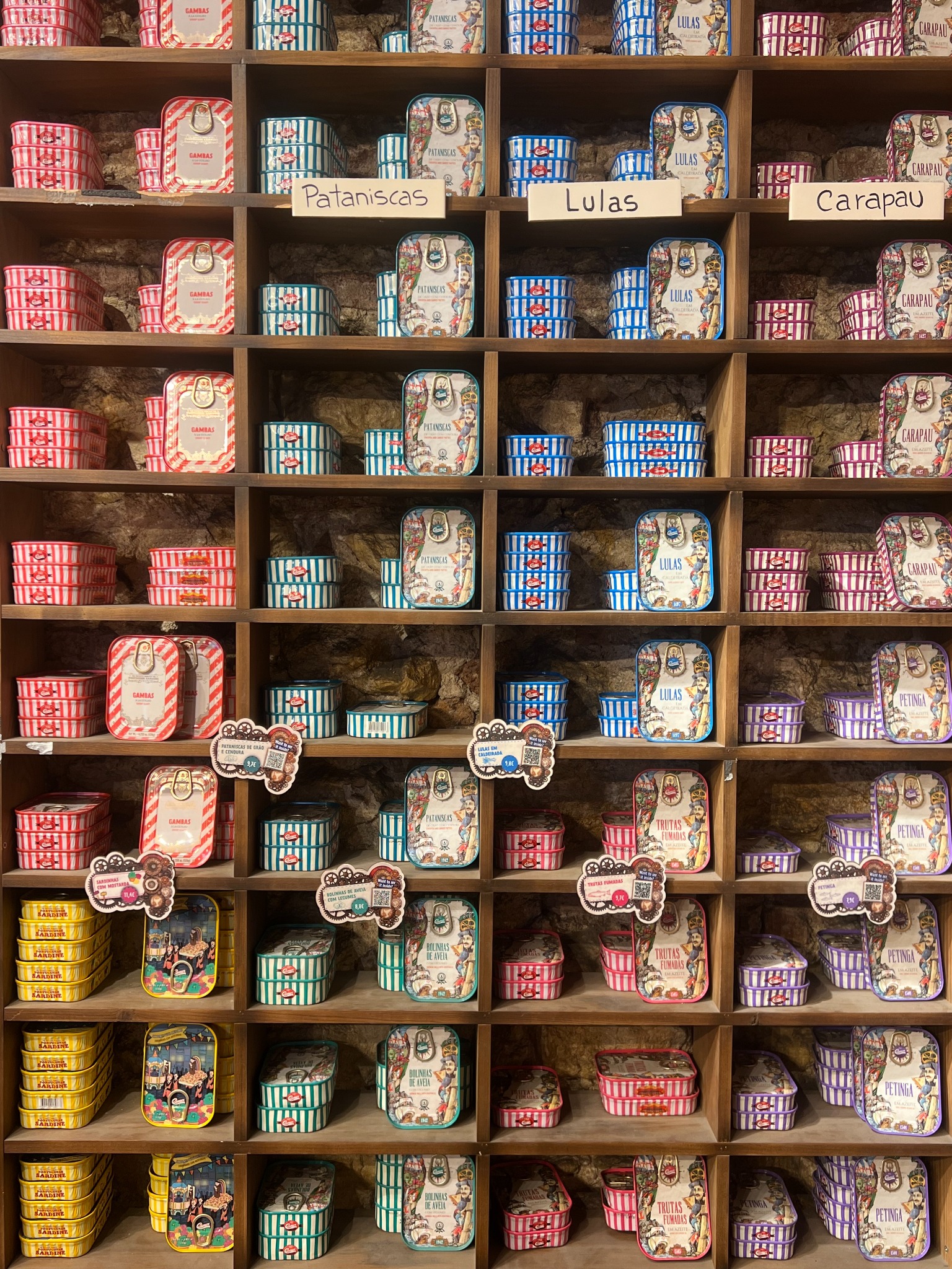 Colorful sardine tins displayed on shelves